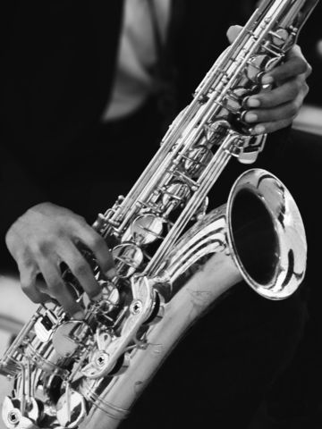 A person plays a saxophone.